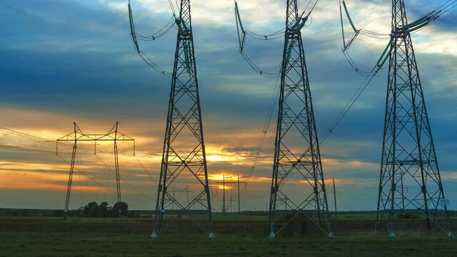 Departure of the camera to the power line against the backdrop of the sunset sky time laps.