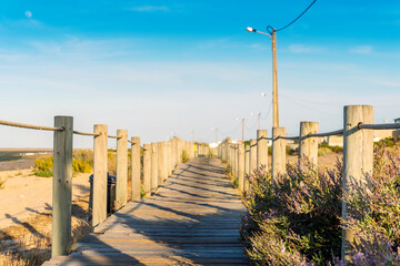 Wooden walkways with view on wetlands of Ria Formosa on Faro Beach Peninsula, Algarve, Portugal