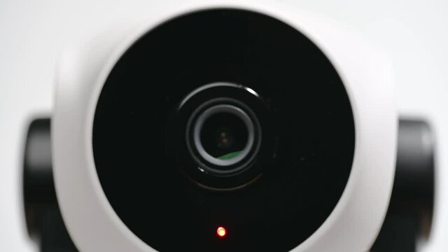 Surveillance IP Internet CCTV camera system remotely operated. Smartphone controlled home security camera moving filming around in 4k footage isolated on white background.
