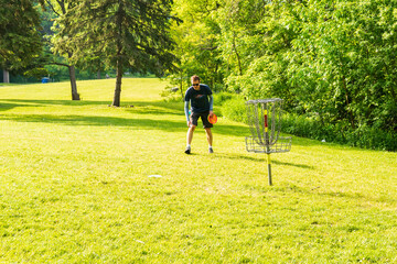 Disc golf is a flying disc sport in which players throw a disc at a target; it is played using...