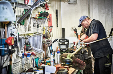 Craftsman working on new project in his workshop. Old master at work