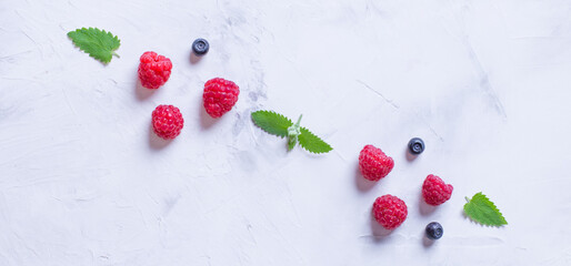 An ornament of raspberries and blueberries on a light background.