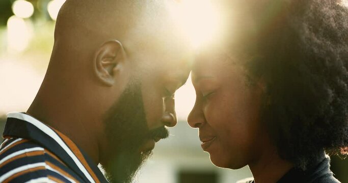 African couple in love outside in sunlight flare