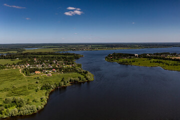 panoramic view from the drone to the village of a large lake and forest and fields and roads 