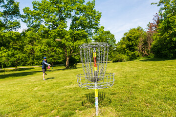 Disc golf is a flying disc sport in which players throw a disc at a target; played using rules like...