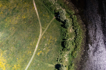panoramic view from the drone to the village of a large lake and forest and fields and roads 