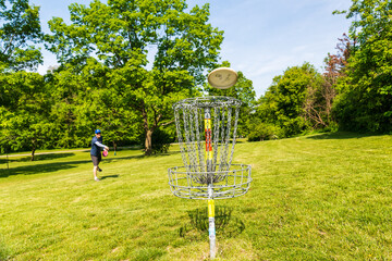 Disc golf is a flying disc sport in which players throw a disc at a target; played using rules like...