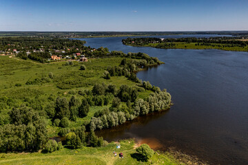 panoramic view from the drone to the village of a large lake and forest and fields and roads 