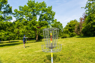 Disc golf is a flying disc sport in which players throw a disc at a target; played using rules like...