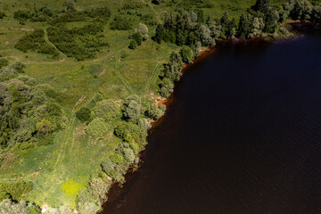 panoramic view from the drone to the village of a large lake and forest and fields and roads 