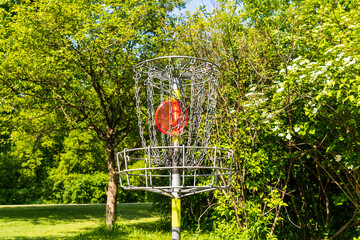 Disc golf is a flying disc sport in which players throw a disc at a target; it is played using...