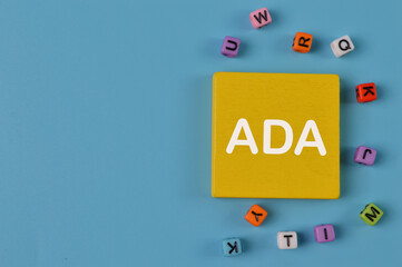 Wooden cube written with ADA stands for Americans with Disabilities Act