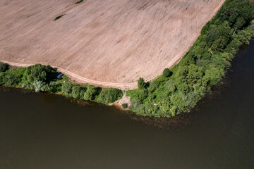 panoramic view from the drone to the village of a large lake and forest and fields and roads 