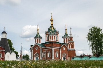 Fototapeta na wymiar Cross-driven cathedral in Kolomna Kremlin from red bricks with golden domes. Russian Orthodox Church