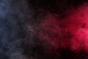 Artificial smoke in white-red light on a black background