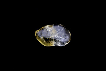 Citrine jewel stone texture on black background. Macro closeup.