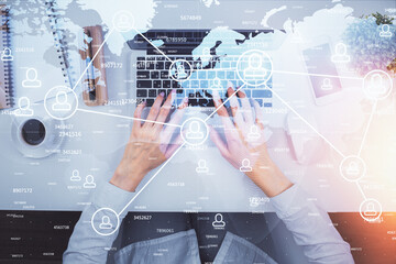 Double exposure of woman hands working on computer and social network theme hologram drawing. Top View. People connection concept.