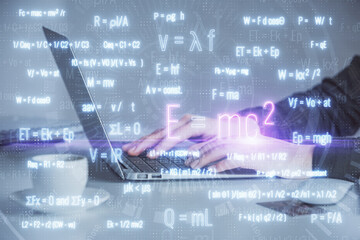 Double exposure of woman hands typing on computer and formula hologram drawing. Education concept.