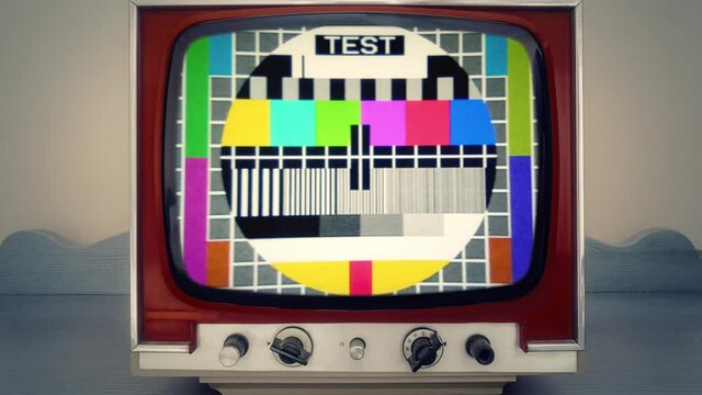 An old television set inside a room, showing a tv test pattern, with the color hue changing over time.
