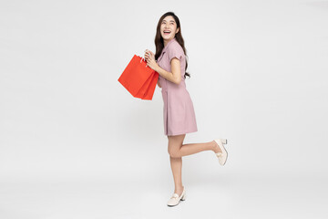 Young Asian woman holding red shopping bags isolated on white background