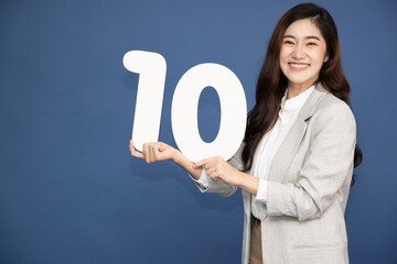 Young Asian businesswoman showing number 10 or ten isolated on blue background