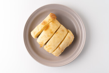 Freshly baked ciabatta bread is placed on a plate