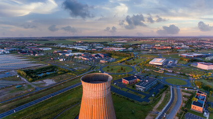 Old metal factory chimney in Caen, Colombelles, Normandy, drone photo at sunset, industrial area - obrazy, fototapety, plakaty