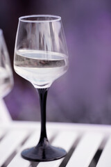 Glasses with white wine close up. Sunset on a lavender field. Feast of Beaujolais. Selective focus