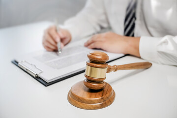 Lawyer preparing to sign a contract reading documents at meeting