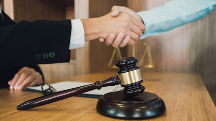 Lawyer preparing to sign a contract reading documents at meeting