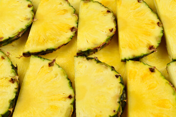 Pineapple juicy yellow slices background. Top view.