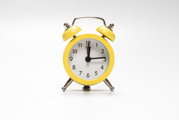 Yellow alarm clock isolated on a white.