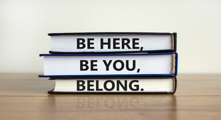Diversity, inclusion and belong symbol. Books with words 'be here, be you, belong' on beautiful wooden table, white background. Business, diversity, inclusion and belong concept. Copy space.