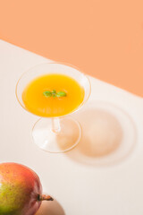 Summer stationery still life scene with mango and mango juice, soft, pastel colors