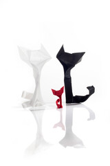 Origami cats over white background