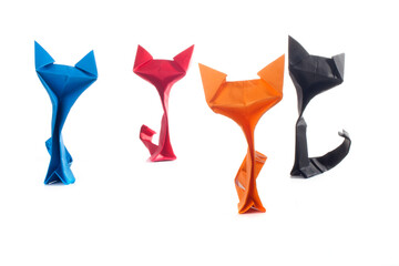 Origami cats over white background