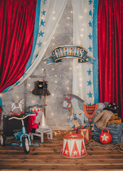 Bright circus decorations. The decoration of kettlebells, digital curbstones, a beautiful painted horse, drums, gymnastic clubs on the background of a gray wall. Circus concept. Vertical frame.