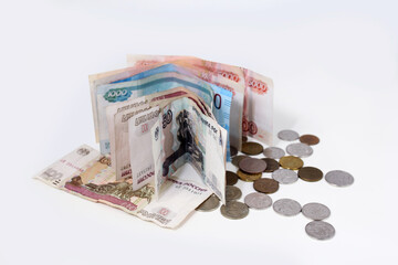 Banknotes and coins of the Russian ruble on a white background close up