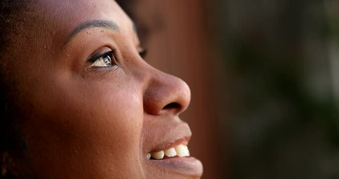 African woman looking at sky with HOPE and FAITH, Person feeling gratitude and spiritual
