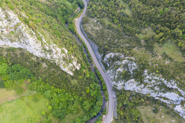 New asphalt road with retaining walls. Beautiful summer sunny day from above.  Aerial shot.