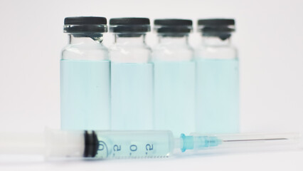 Medical ampoules and insulin syringe isolated on white background, vaccination concept