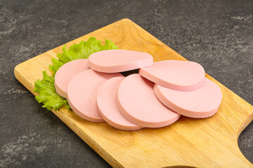 Sliced sausage snak over board