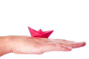 Red origami boat in hand over white background. - Powered by Adobe