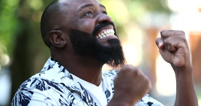 Black African man screaming with joy, overjoyed excited person