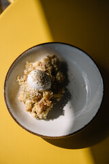 apple crumble with sesame seeds and ice cream bowl