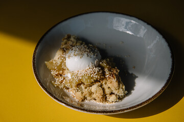 apple crumble with sesame seeds and ice cream bowl