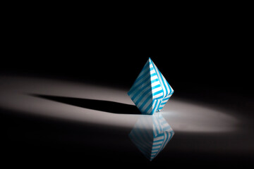 Origami balloons made of colored papers isolated on black background.