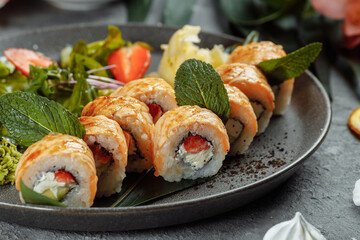 Maki Sushi - a roll of cream cheese, strawberries, avocado and fried salmon. Summer seasonal sushi rolls
