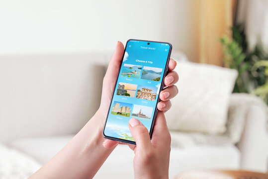 Choosing a travel destination with smart phone concept. Modern app with chose a trip option. Phone in woman hand. Close-up.