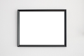 Mockup frame in black hanging on a white wall